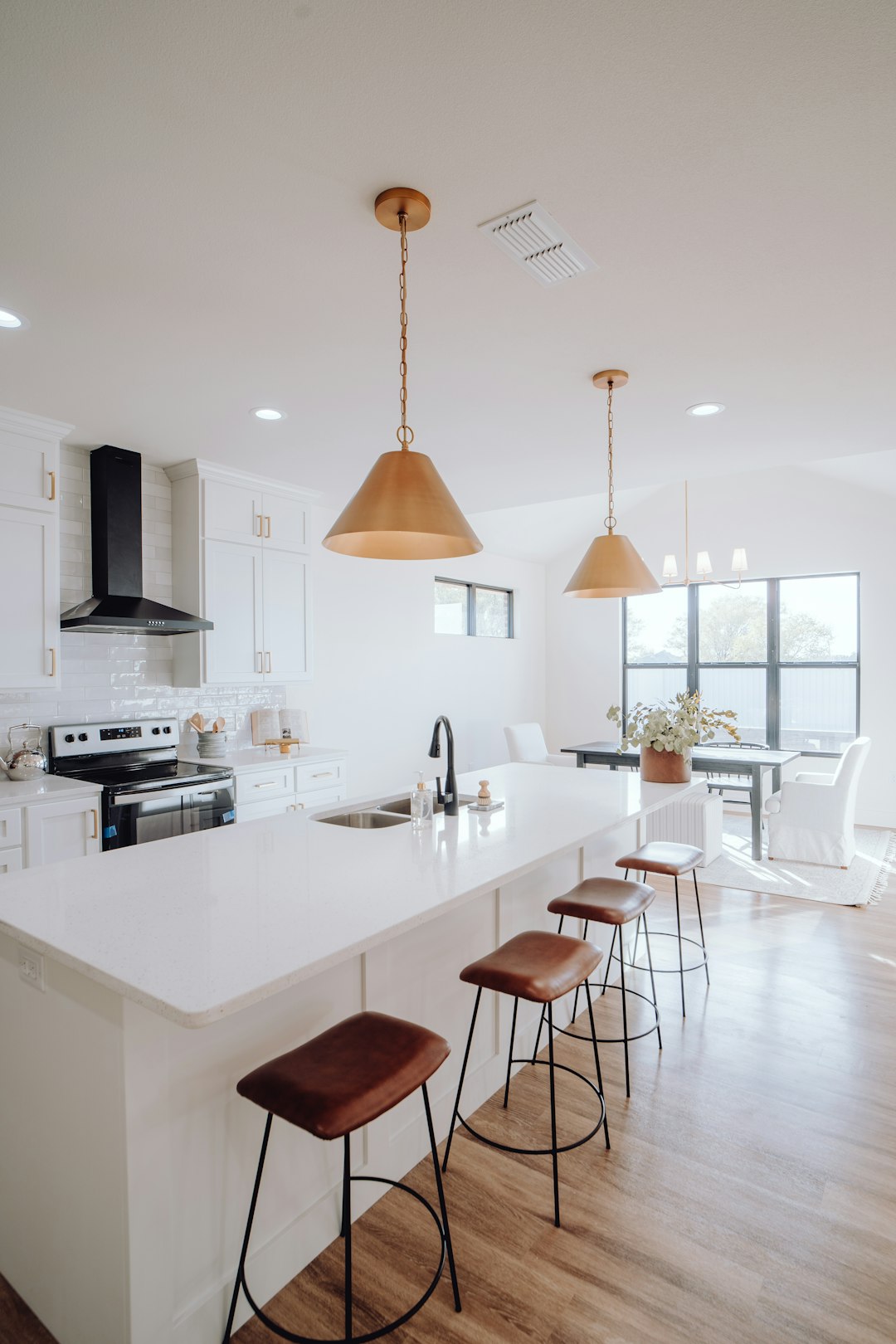 a-large-kitchen-with-a-center-island-and-bar-stools-cyecxtkpttq